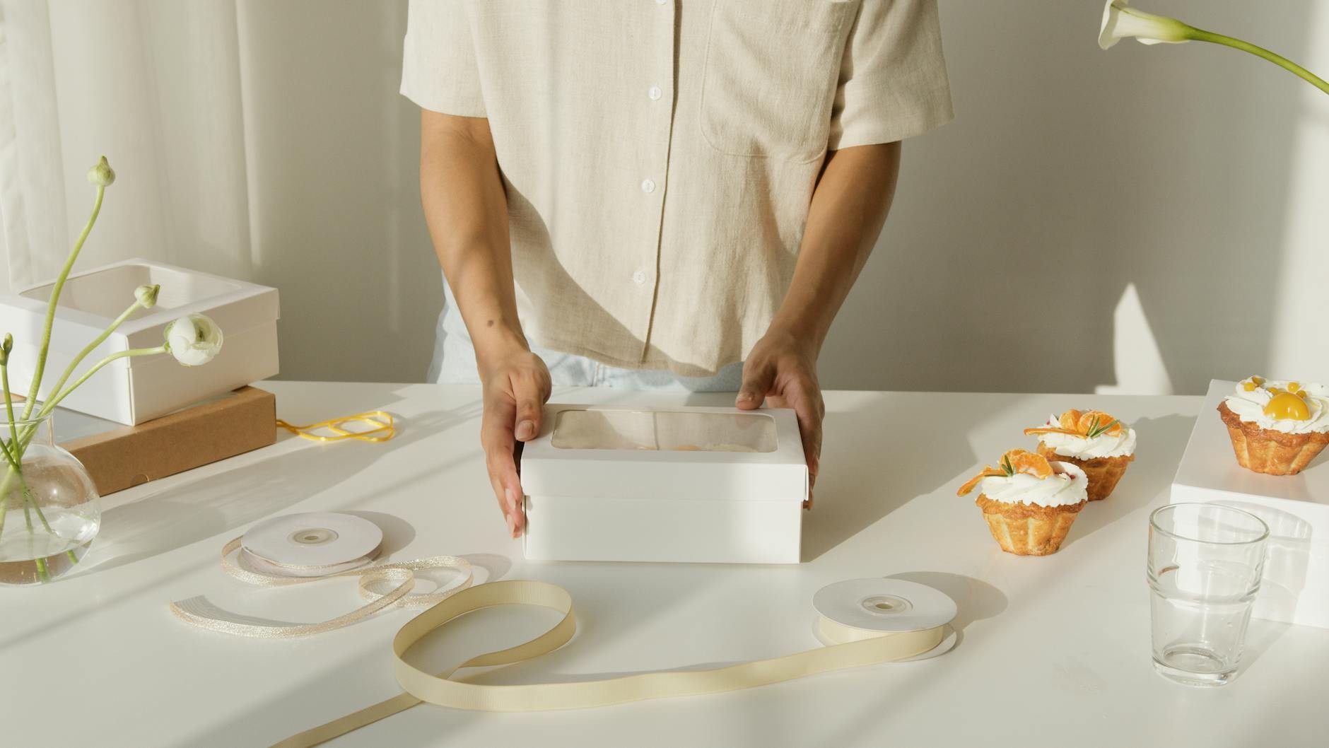Studio workspace with pastry boxes arranged on white backdrop